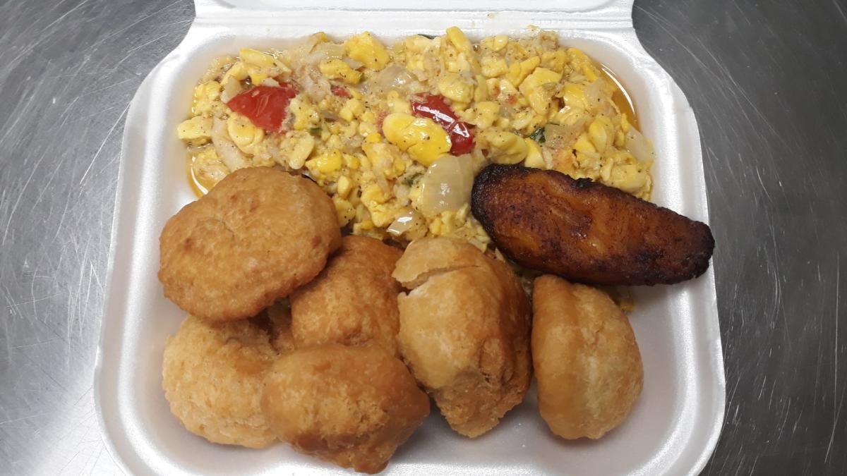 Ackee & Saltfish served with Fried Dumplings- (LG) Well seasoned ackee & salted cod fish, and crispy, golden dumplings, this traditional dish is sure to satisfy your taste buds. Enjoy the savory flavors and cultural experience with every bite.
