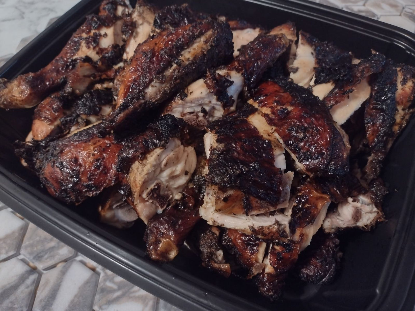 Jerk Chicken By The Pound-Made with traditional Ackees Jamaican spices and grilled to perfection, each bite is bursting with a mouthwatering blend of heat and tang. A must-try for any food lover looking for an elevated and satisfying meal experience.