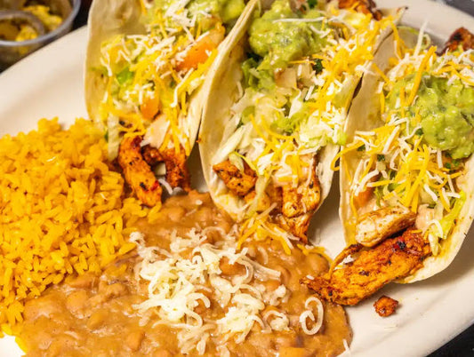 Wicked Taco Supreme (3 Chicken Tacos)- Topped with lettuce, pico de gallo, guacamole, cheese, and sour cream. &nbsp;Served with rice and pinto beans on the side.