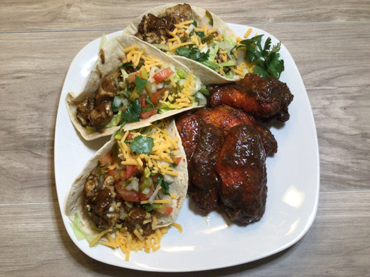 Jerk Chicken Wings (5 pcs) and Jerk Chicken Tacos (3 pcs)- 5 savory jerk chicken wings and 3 delectable jerk chicken tacos. Topped with fresh lettuce, onions, tomatoes, guacamole, cheese, and sour cream, each bite is bursting with flavor.