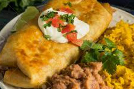 Wicked Chimichanga- Fried burrito, filled with rice, pico de gallo, cheese, and house sauce. your choice of chicken, beef, or beans. Served with rice and pinto beans on the side.
