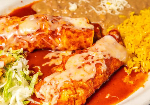 Wicked Enchiladas- Two enchiladas (choose your protein) smothered with your choice of red enchilada sauce and sour cream. Covered with cheese. Served with rice and pinto beans on the side.