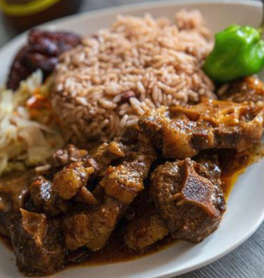 (2) Ox Tails Dinners, complete with a savory combination of stewed cabbage, rice, peas, and sweet plantain. Our expertly prepared ox tails will satisfy your taste buds while providing a nutritious meal