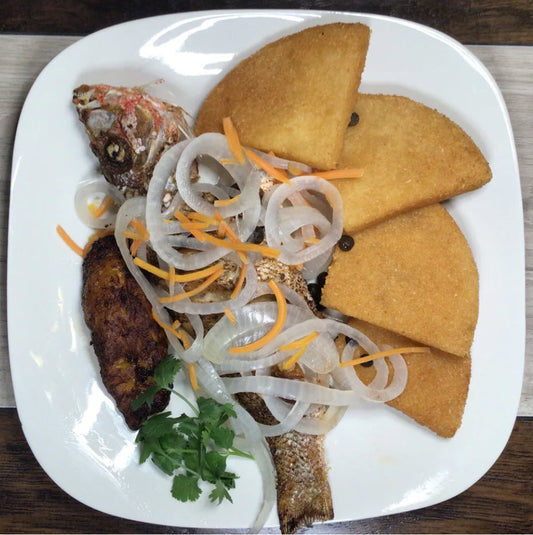 Escovitch (1) Fish (Snapper)dish. Savor the tender and flaky fried fish paired with Bammy and sweet plantain, creating a delightful combination. Indulge in this traditional Jamaican dish and taste the true essence of Jamaican cuisine.