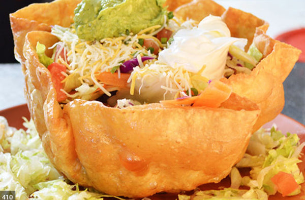 Wicked Fajita Salad Bowl (Chicken)-Taco shell nestled with lettuce, pico de gallo, cheese, sour cream, guacamole, corn salsa and, house dressing. Served with well seasoned tender strips of Chicken with green peppers and onions on the side.