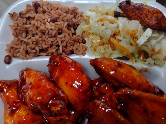 Barbi Sweet- Chili Chicken Wings Combo (10pc)- served with rice and peas, stewed cabbage, and plantains. Made with succulent chicken wings coated in a deliciously tangy and slightly spicy chili sauce, each bite is a burst of flavor.