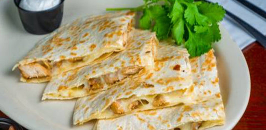 Wicked Chicken Quesadilla- made with seasoned and grilled chicken, topped with melted cheese, and folded in a crispy tortilla. Enjoy a delicious and satisfying meal that is high in protein and a good source of calcium.
